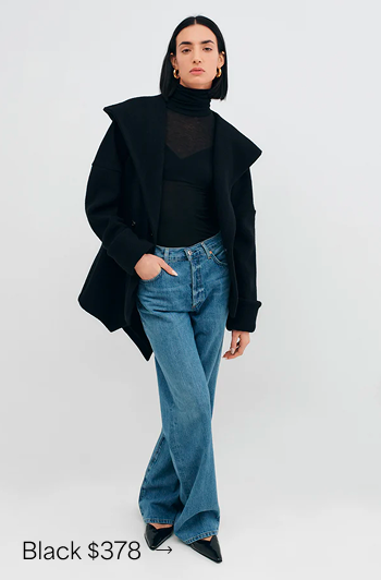 Emily in The Kyoto Wool Jacket and blue jeans poses casually with one hand in her pocket.