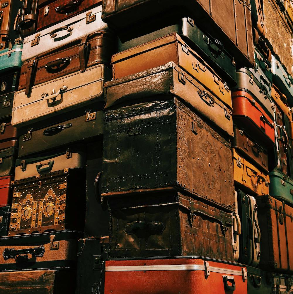 A seemingly endless stack of vintage leather suitcases. 