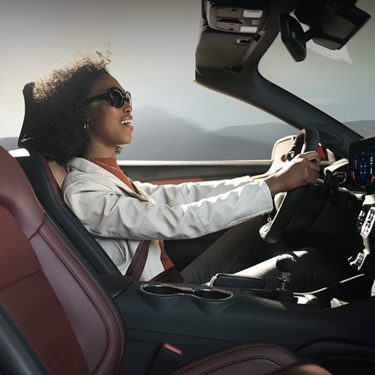 A woman driving a Ford Mustang&reg; GT Premium Convertible