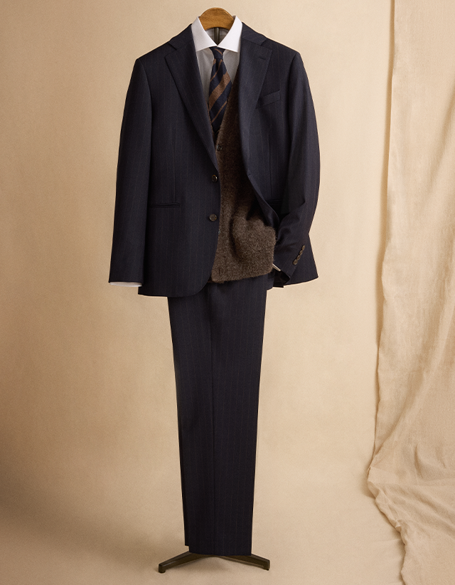 Smarten things up with a classic navy suit in a tailored fit and a patterned wool tie for a bit of character.