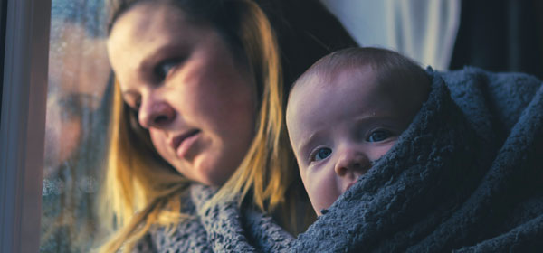 Chloe and her baby wrapped up together in a blanket