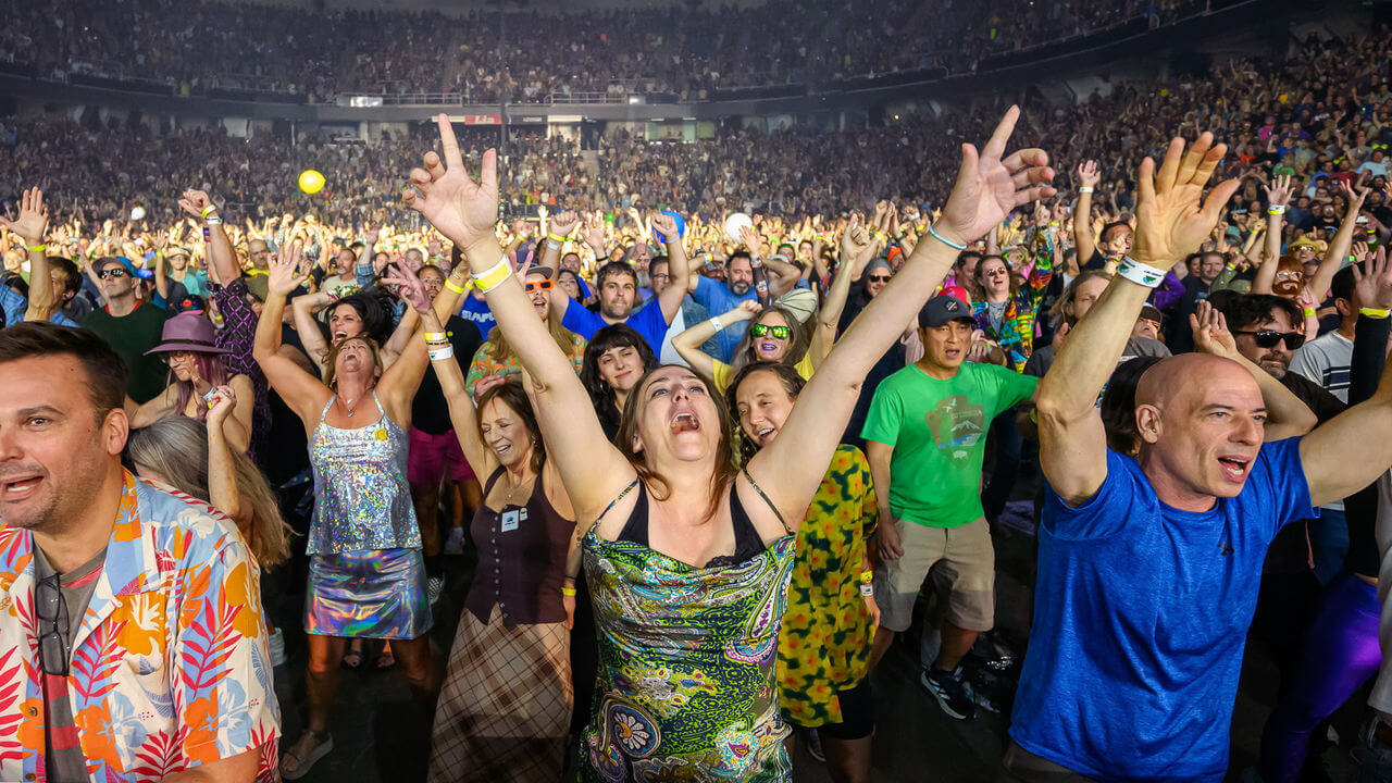 Music fans dance and sing along to Phish at the MVP Arena.