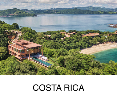 A bird’s-eye view of a large body of water, lush trees and hilltops appear in the foreground and background. Text reads: Costa Rica.