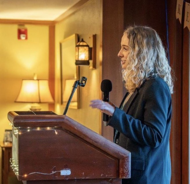 Riley McDevitt, pictured giving a keynote speech for Camp Kesem, an organization that offers free summer camps and year-round programming for children whose parents have cancer.