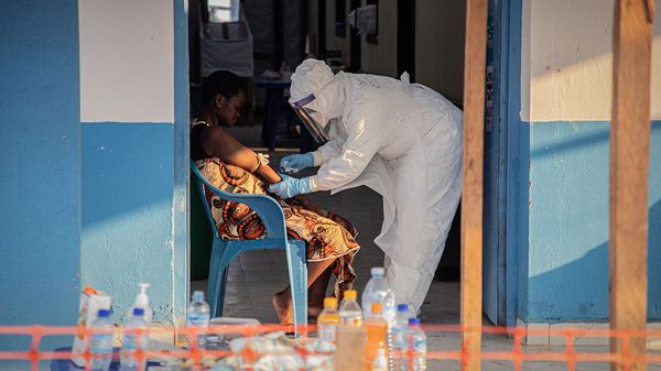 A healthcare worker takes samples from a patient suffering from Ebola virus disease at the Ebola Treatment Centre in Bunia, Congo