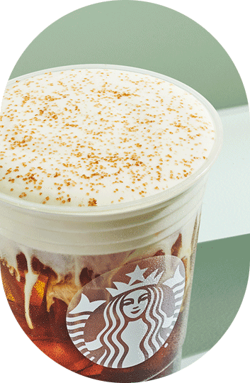An iced Starbucks coffee drink with cold foam on top.