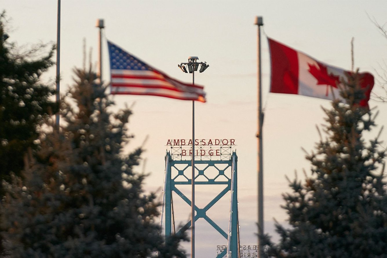 American and Canadian flags flying together