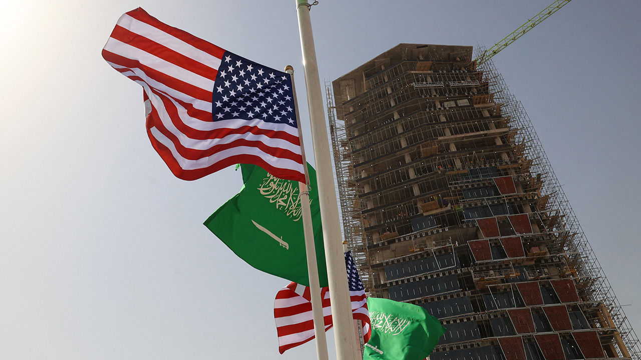Saudi and US flags flutter in front of a building under construction on a main road in Riyadh on May 12, 2025, ahead of a visit by US President Donald Trump
