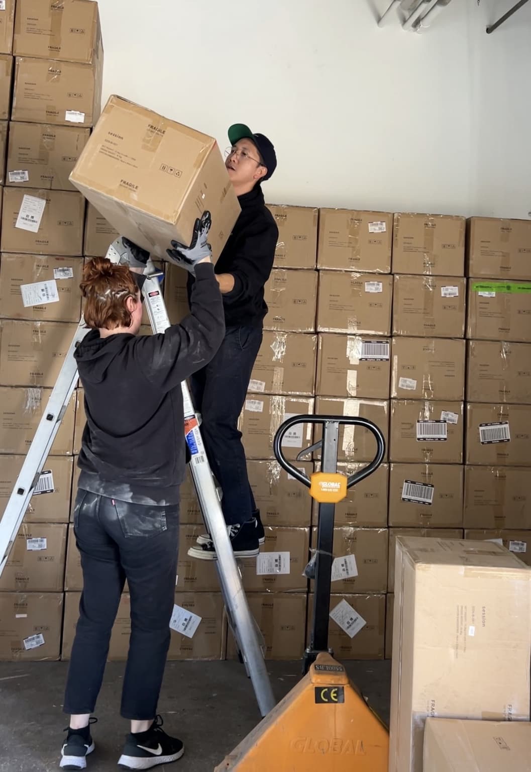 Co-founders Esther and Vinh moving bong boxes