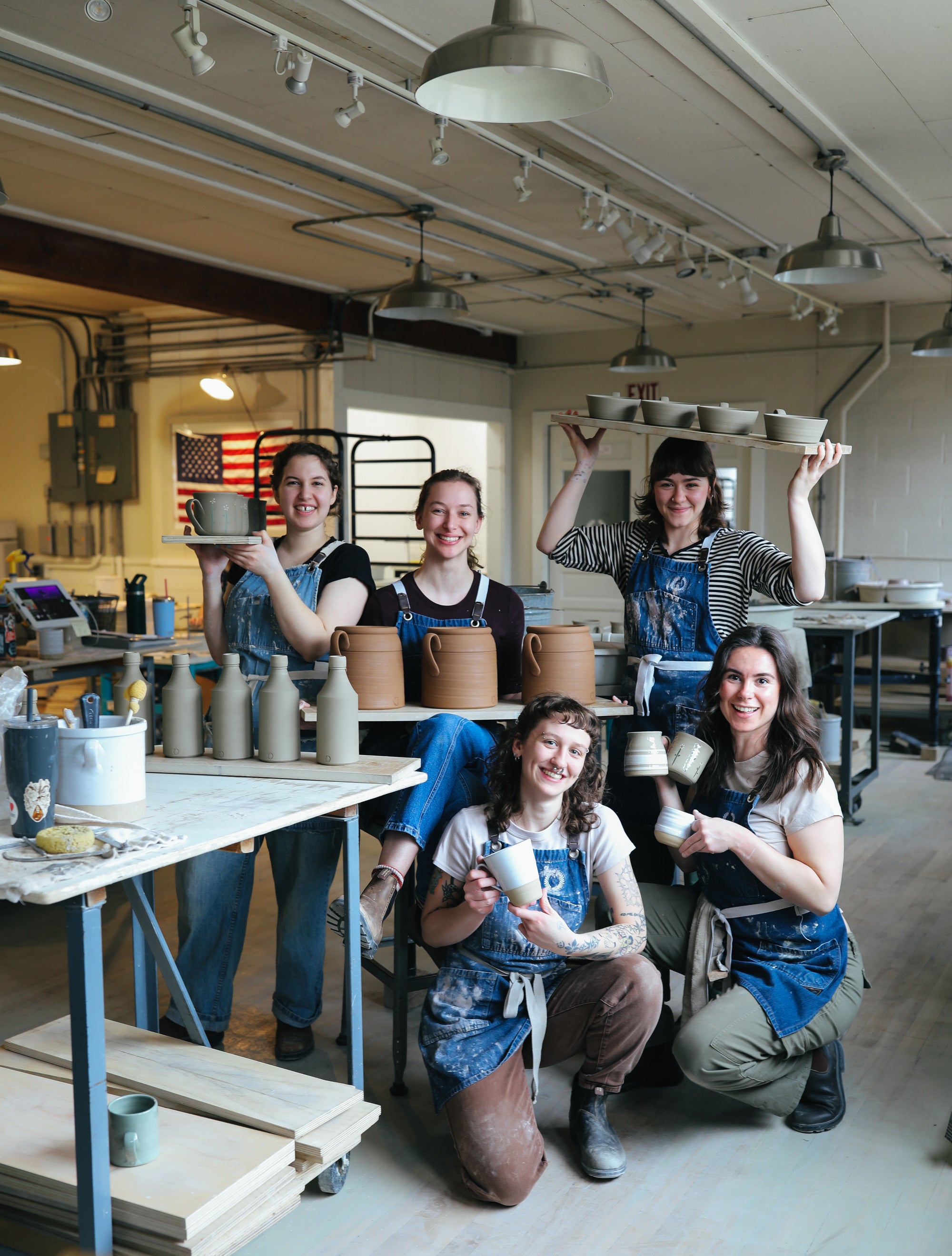 A potter finishing a piece at the studio table