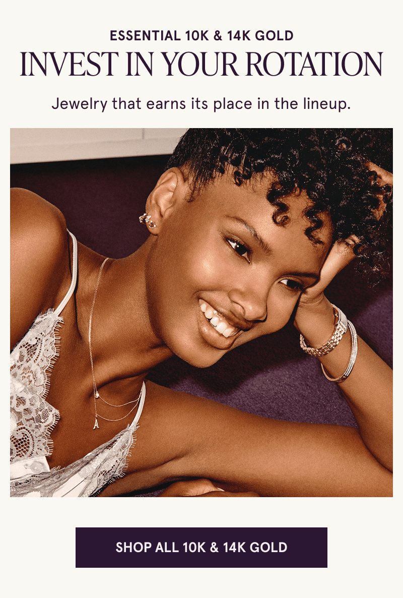 A model wearing gold gemstone jewelry. Invest in your rotation. Click here to shop all 10K and 14K gold