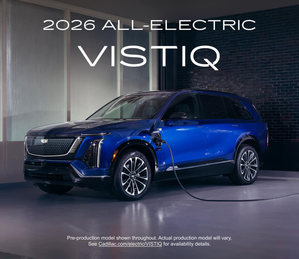 Three-quarters view of a Blue 2026 VISTIQ plugged in and charging in a garage