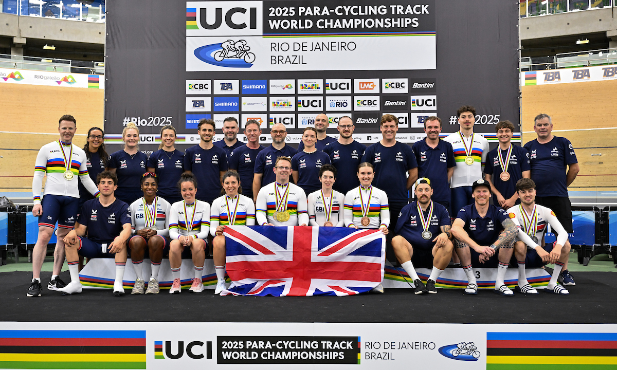 Great Britain Cycling Team riders and team staff pose for a photo on the podium of the 2025 UCI Para-cycling Track World Championships in Rio.