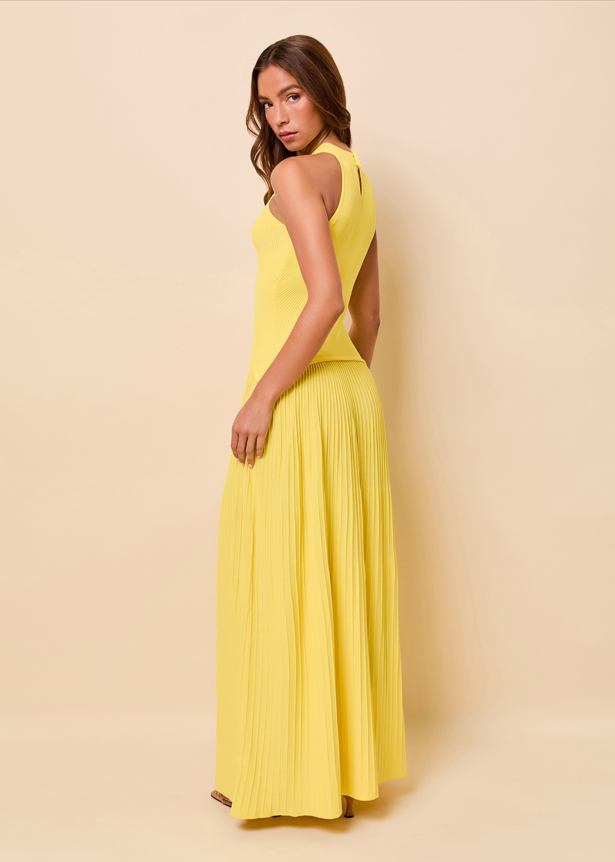 woman in halter bright yellow light knit dress
