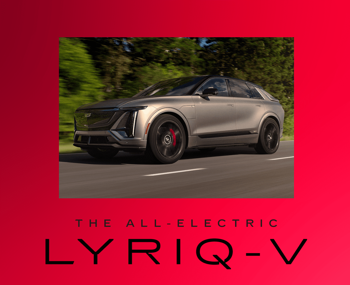 The 2026 LYRIQ-V in Magnus Metal Frost driving down a tree-lined road.