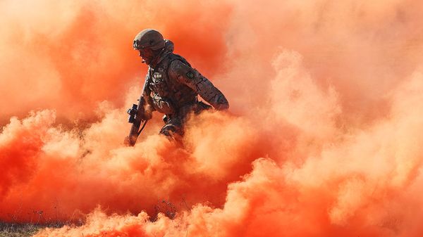 A soldier of the United Kingdom's 2nd Battalion Royal Anglian infantry unit storms an enemy position in a simulated attack during the NATO Brilliant Jump military exercises.