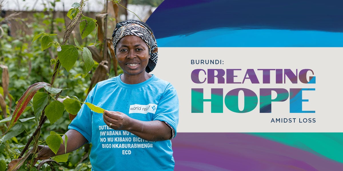 Woman holding a plant in Burundi. Creating hope.