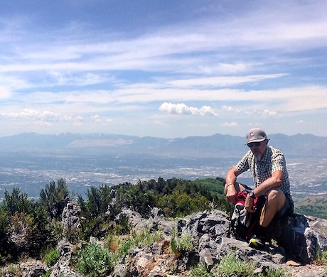 a man sitting on top of a mountain