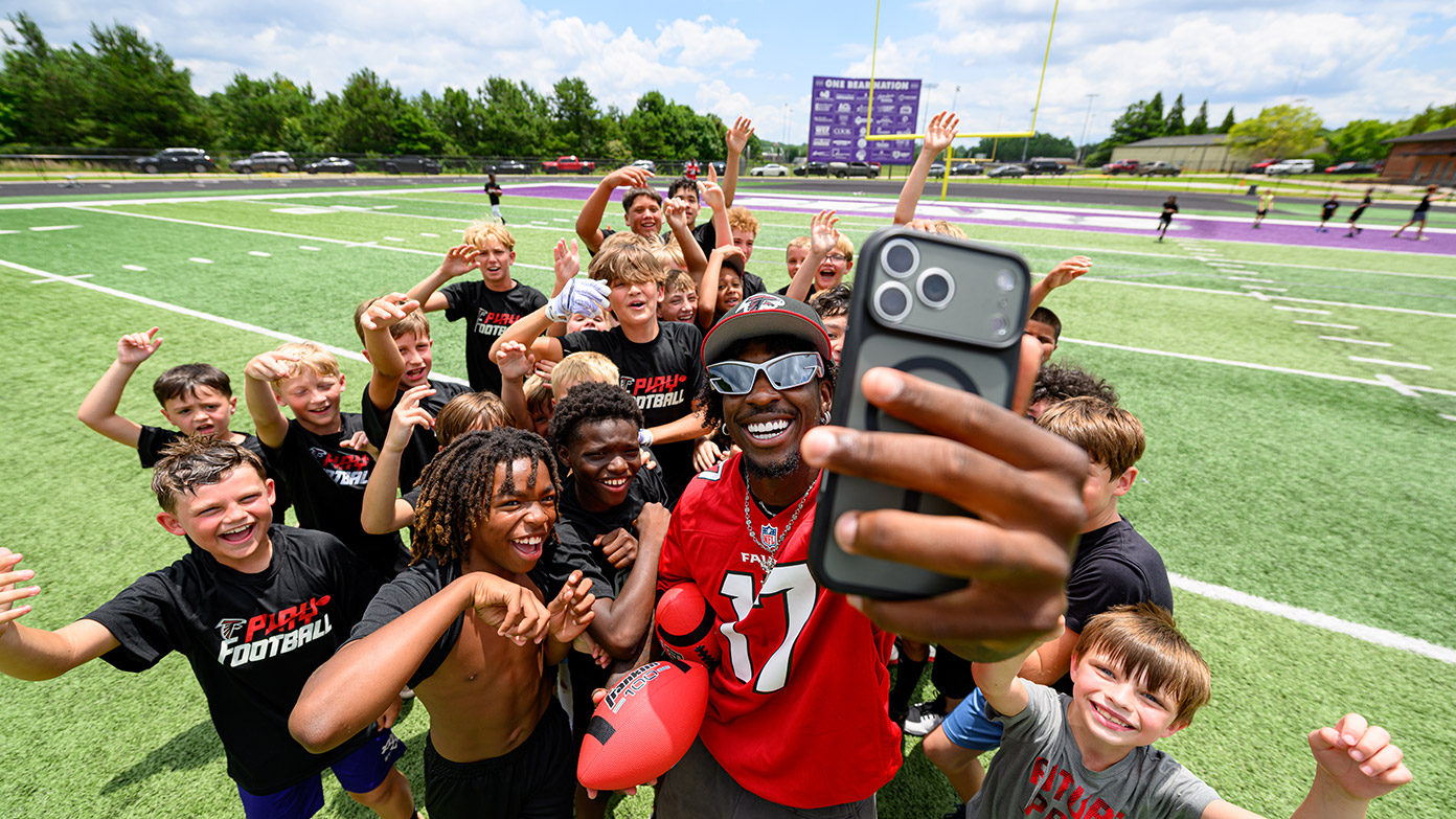 Youth pose for a photo during youth football camp