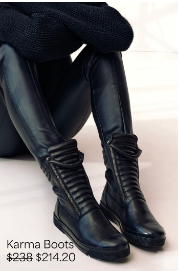 Yada seated in black leather leggings wears The Karma Boots with padded panels and front zippers.