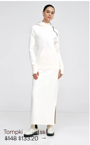 Mily stands in The Tompkins Sweatshirt Dress with a soft, relaxed gaze.