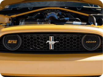 A yellow Ford Mustang&reg; vehicle with its hood popped