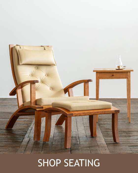 The Lolling Chair and ottoman with a square end table all shown in cherry. Text reads: Shop Seating