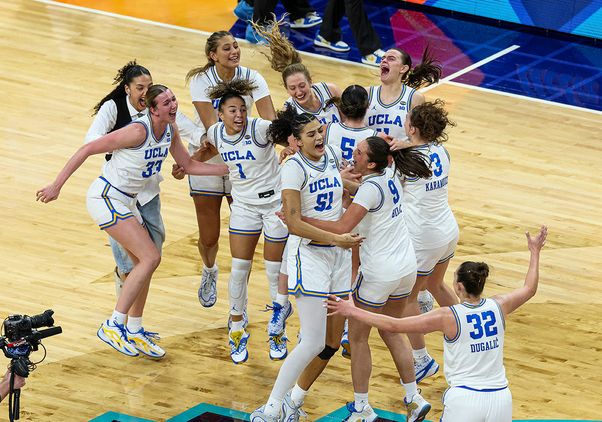 UCLA women's basketball team celebrating on the court