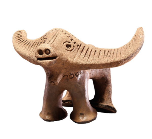 Smiling buffalo figure made of incised earthenware.