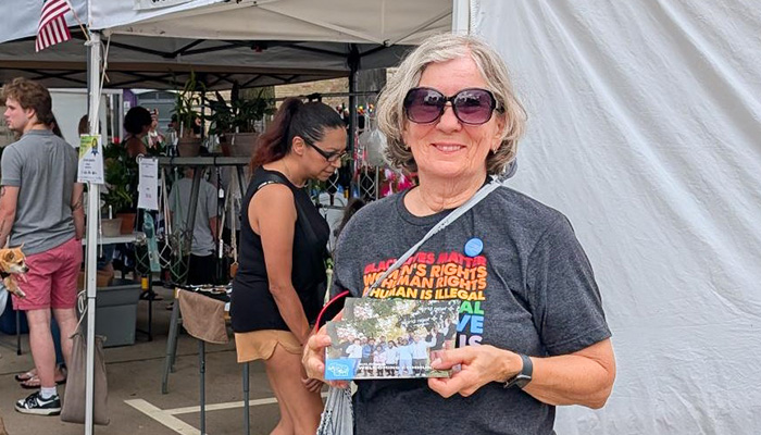 Deb Martin, volunteer at World Relief holding card.