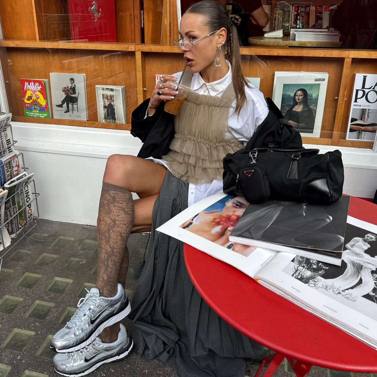 An image of a person sitting at a table wearing grey Nike P-6000 trainers