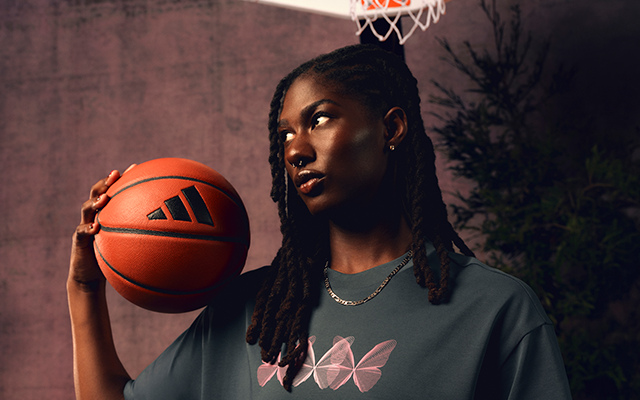 Oliviyah Edwards holding a basketball, styling the adidas Basketball x Ryoko Rain "Dear Daughter" collection inspired by transformation, heritage storytelling and the butterfly effect