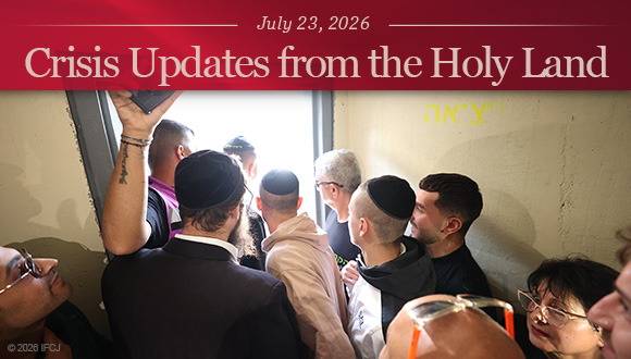 People gathered in a crowded bomb shelter.