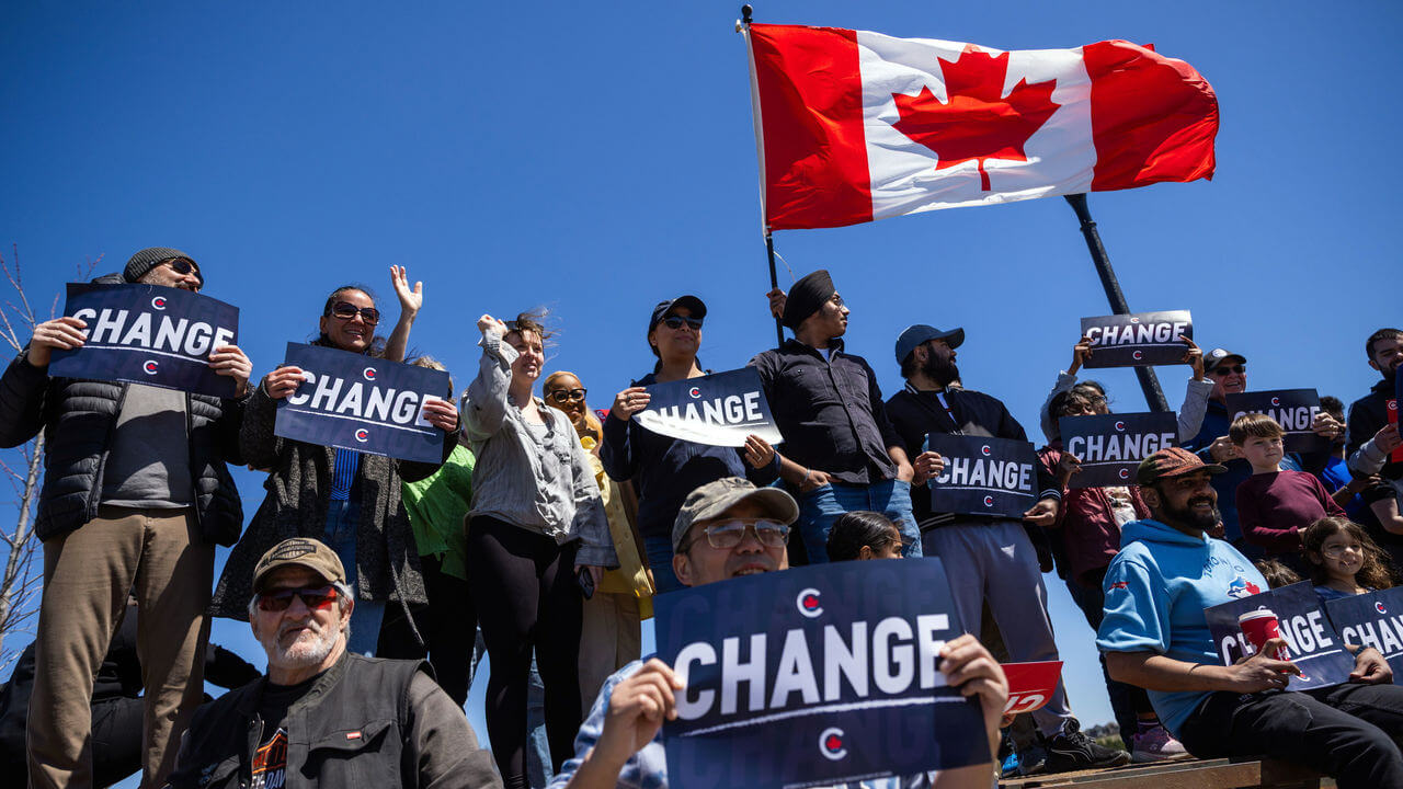 Supporters of Canada's Conservative Party hold signs reading 'change' during a campaign rally.
