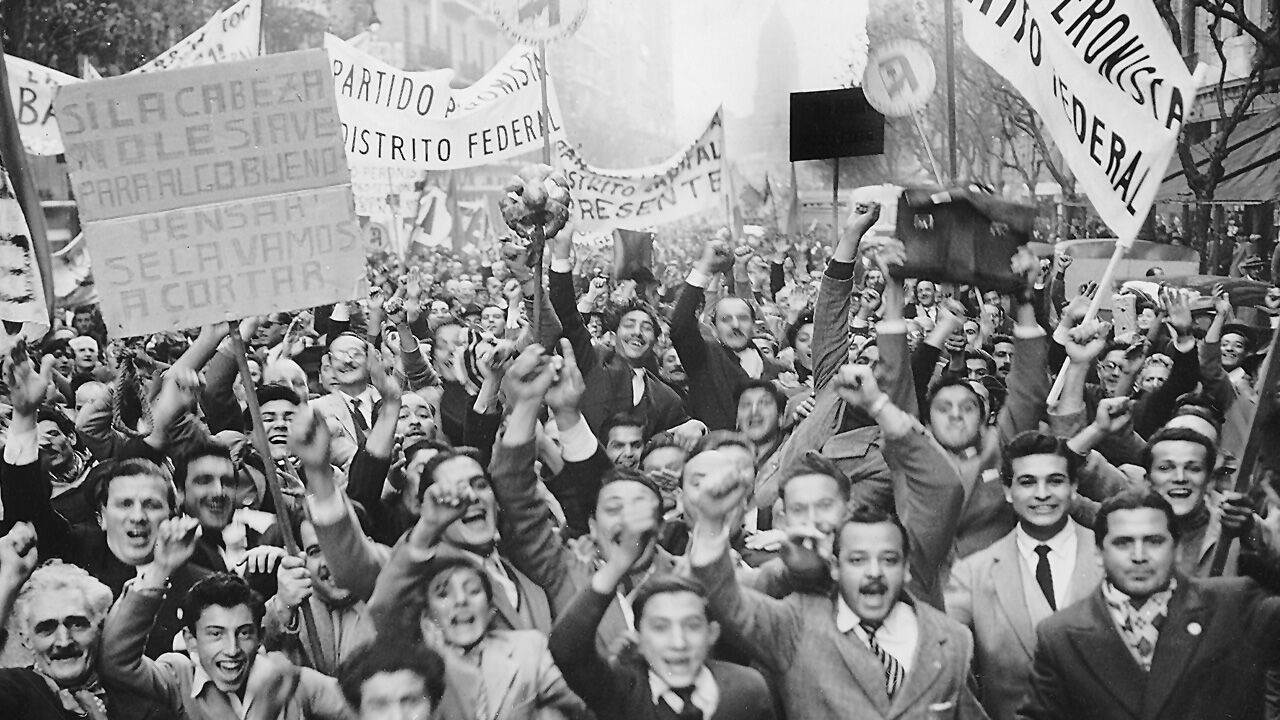 A crowd of Peronist supporters shout and raise their fists during demonstrations in Beunos Aires in 1950