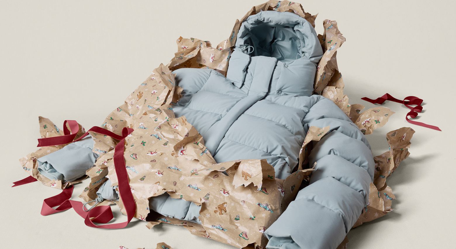 A blue puffer jacket being unwrapped.