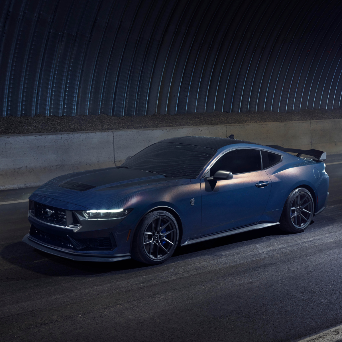 A blue Ford Mustang&reg; Dark Horse&trade; model in motion