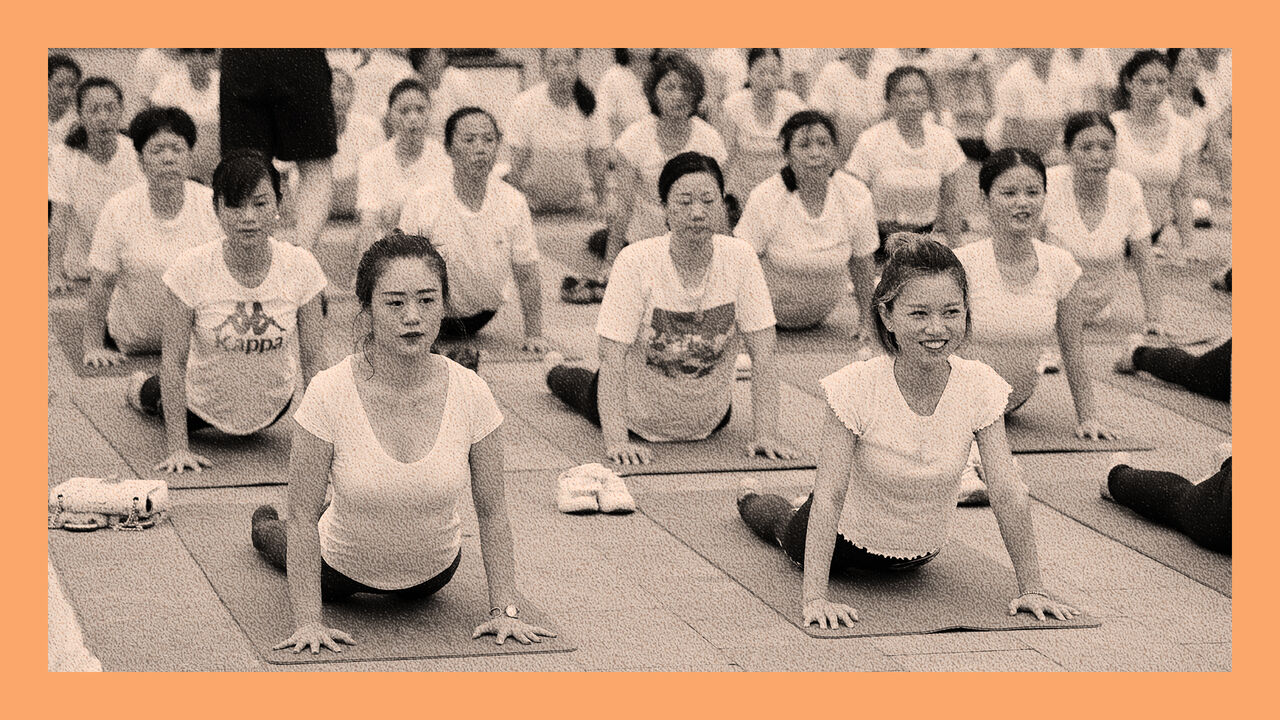 About a hundred people gather to do yoga at Zhuge Liang Square in the morning, in Xiangyang, Hubei Province of China - ahead of International Yoga Day.