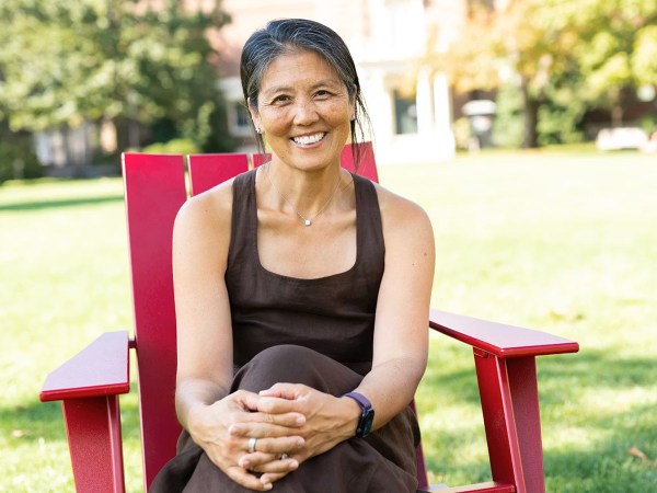 Naomi Ko sitting in a red chair.