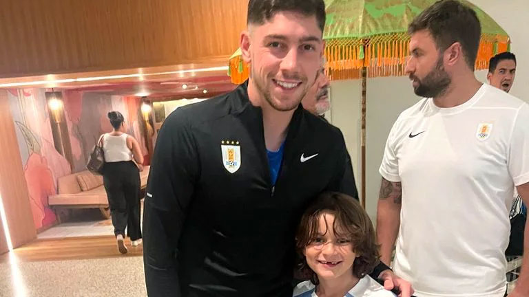 A man and a kid pose for a photo.