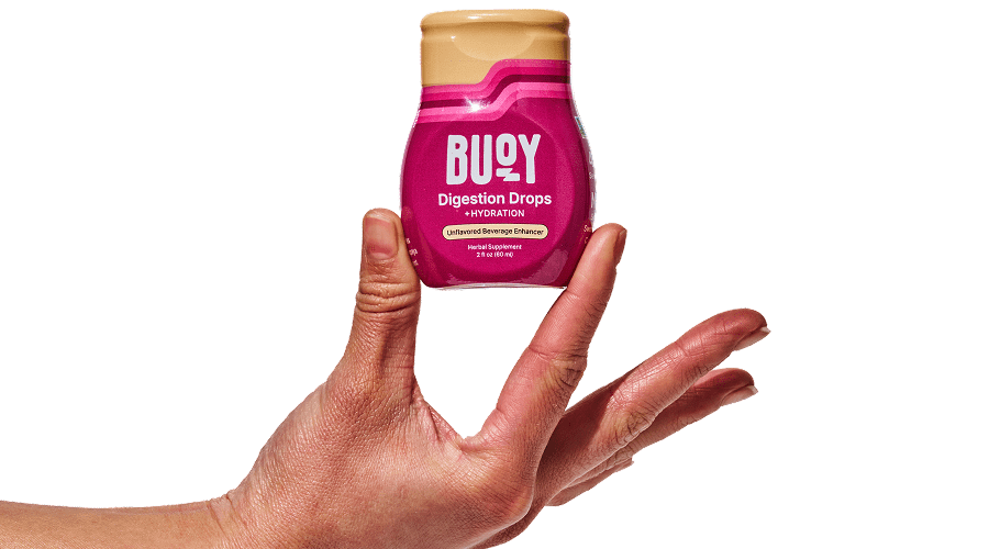 A hand holding Digestion Drops.