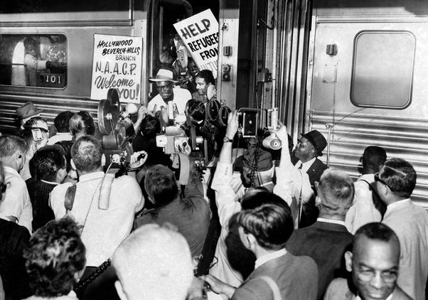 Black-and-white historical photo: Freedom Train passengers are welcomed by a crowd that includes the Hollywood/Beverly Hills branch of the NAACP.