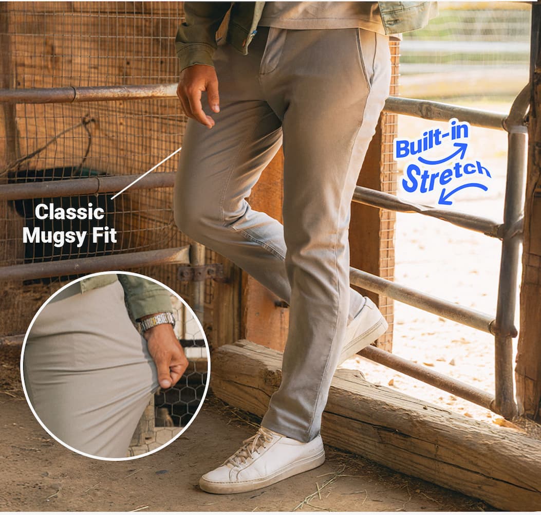 [Image of man in a barn wearing Damens chinos leaning on a gate.] Classic Mugsy Fit. 4-Way Flex.