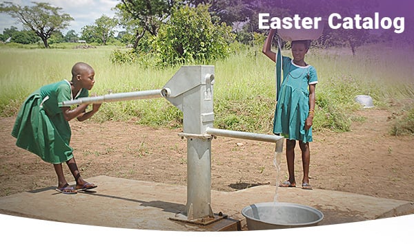 Girls in Ghana pump clean water from a hand-pump well.