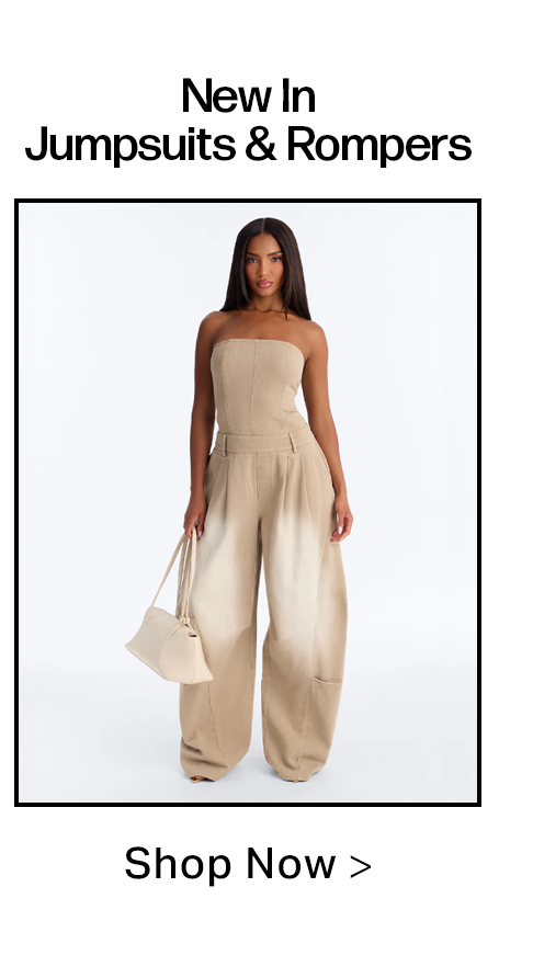 Woman models new tan strapless wide-leg jumpsuit with ombre fade. Holding a beige bag, promoting our latest jumpsuits & rompers collection.