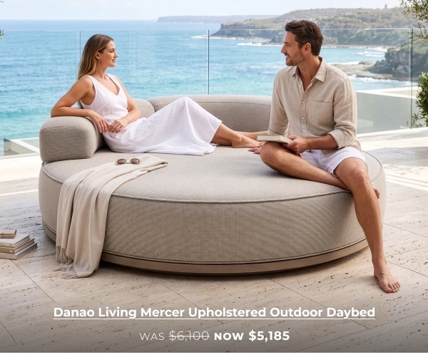 Couple relaxing on large round daybed. Image Text: Danao Living Mercer Upholstered Outdoor Daybed WAS $6,100 NOW $5,185