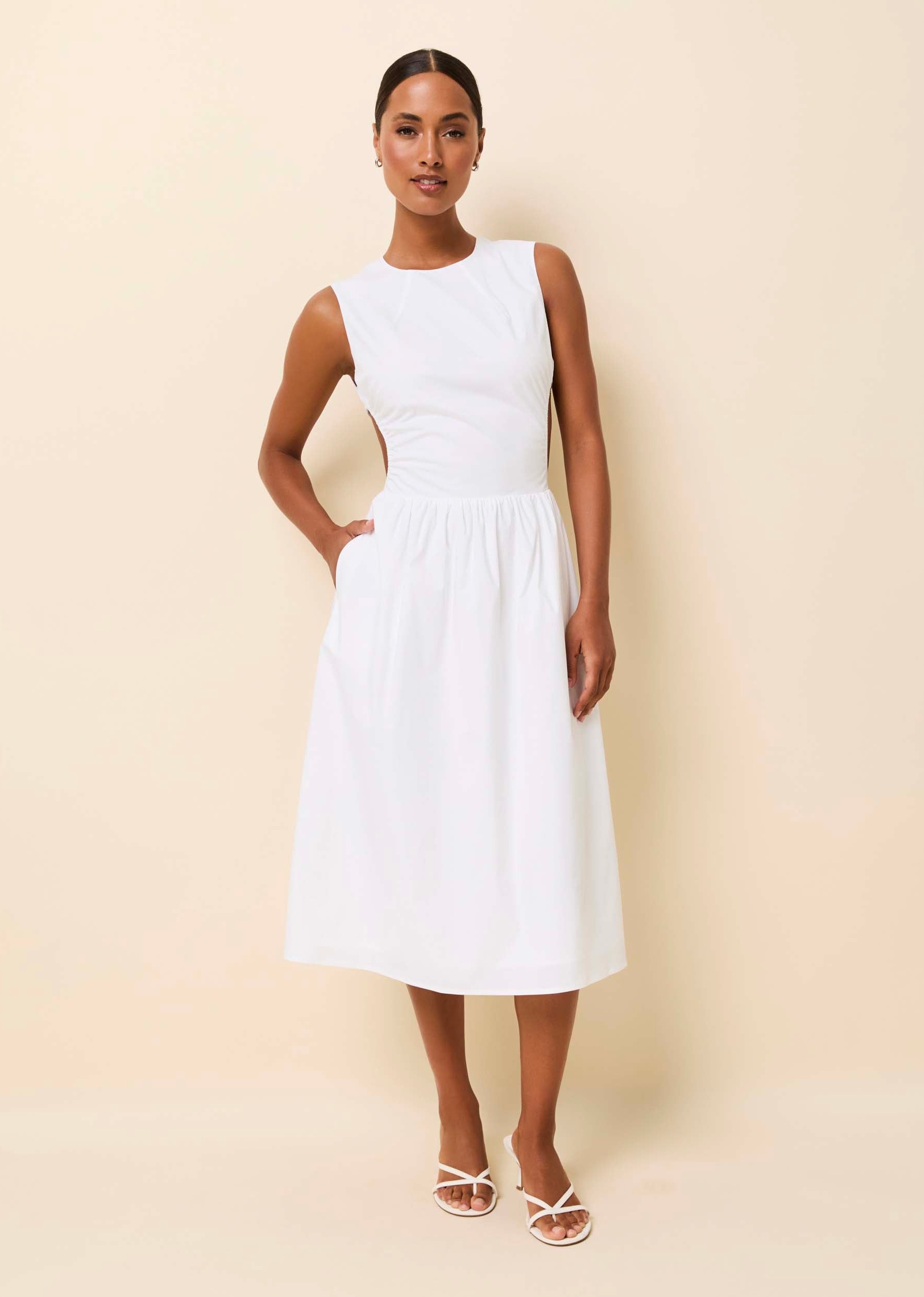 woman in a midi white cotton dress