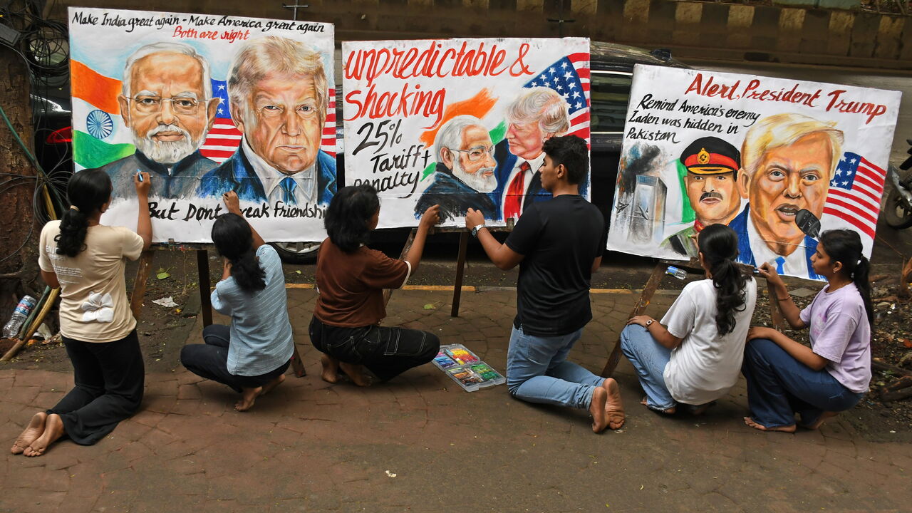 Students from Gurukul School of Art, paint posters with the portraits of Asim Munir, Chief of Army Staff of Pakistan, Prime Minister of India Narendra Modi, and U.S. President Donald Trump
