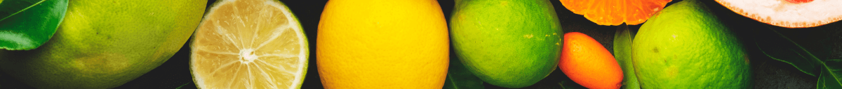 Various citric fruits in the background.