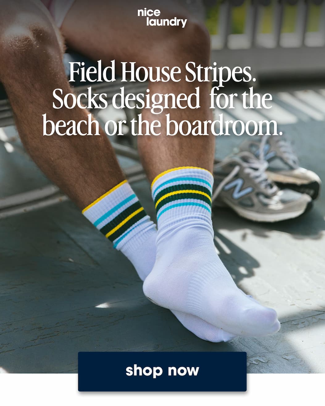 Close up of man sitting in chair wearing yellow/blue/black/white crew socks. Text on image says socks designed for the beach or the boardroom shop now